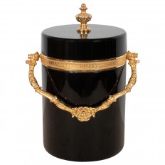 Circular black glass box with decorative gilt trim